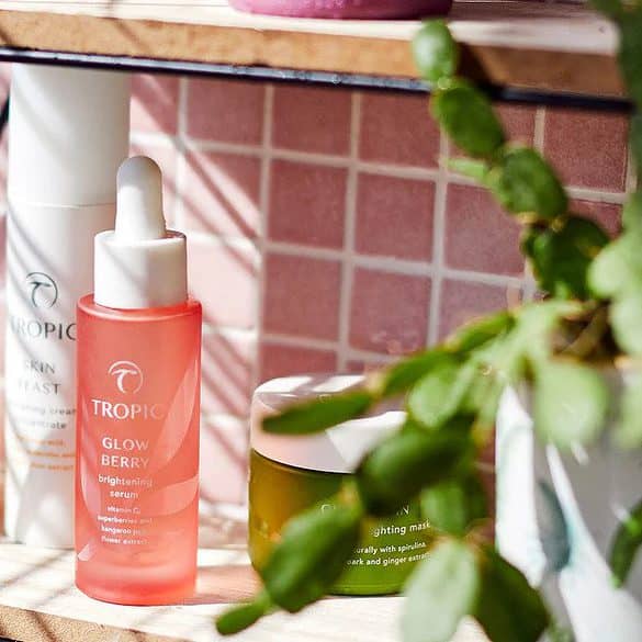 Tropic Skincare products on a pink bathroom shelf